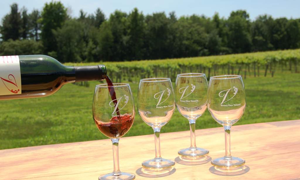 Marquette wine is poured into glasses at an outside wine tasting at Victory View Vineyard.