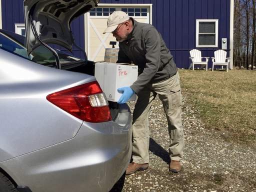 Gerry loading case of wine into car trunk